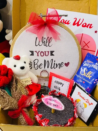 A close-up of the "Will You Be Mine" proposal hamper. It's a sweet and creative way to pop the question or celebrate your love, complete with a teddy, rose, and chocolates.