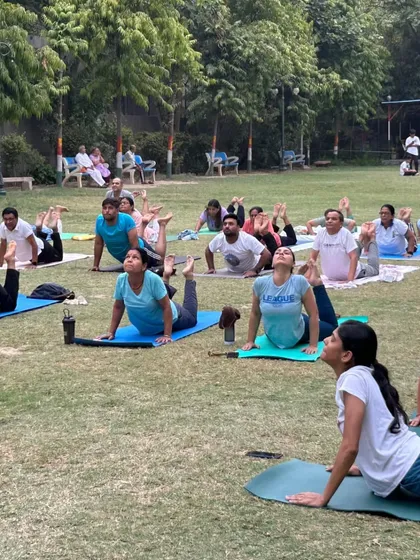 Another angle of the group practicing Bhujangasana (Cobra Pose), showing the scale and engagement of the participants.