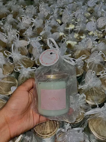 A handheld view of one of our 350 Christmas candles, ready to be gifted. The simple yet elegant packaging makes it a perfect favor for holiday parties and corporate events.