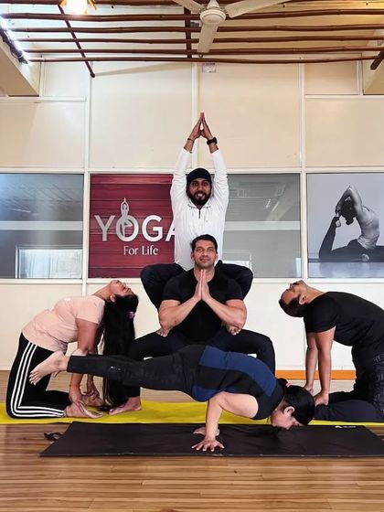This dynamic group pose showcases a combination of balance, strength, and flexibility from every participant. It's a powerful example of what we can create together.