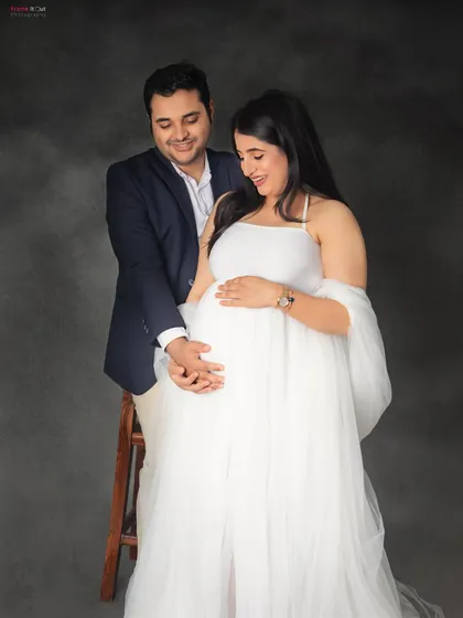 A gentle and loving pose for expecting parents. Holding hands over the baby bump is a simple yet powerful way to show their shared excitement and love.