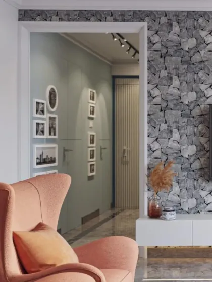 This TV wall makes a bold statement with its stone-texture wallpaper. A simple floating console keeps the look clean and modern, while the cozy peach armchair adds a soft, inviting touch to the corner.