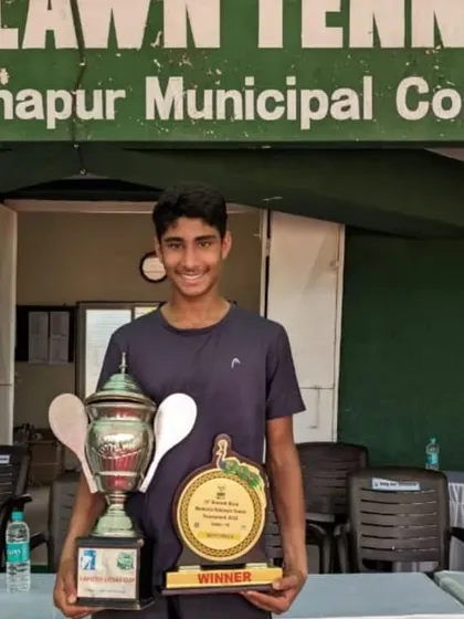 A smiling Tavish with his impressive singles and winner's trophies from the U16 AITA Nationals.