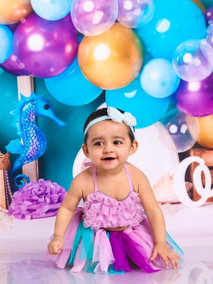 This little mermaid is ready for her underwater adventure. The vibrant colors of the set and her costume make for a stunning photograph.