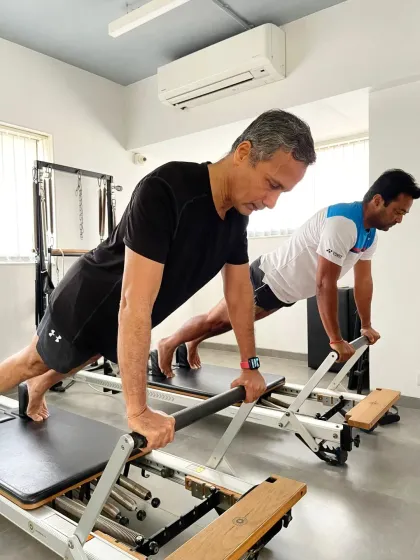 Tennis legend Leander Paes and our founder Samir Purohit demonstrate a powerful plank on the reformer. Pilates helps athletes like Leander maintain core stability and strength, crucial for a long and successful career.