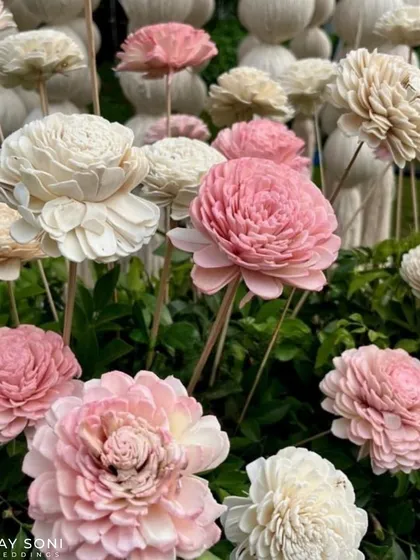 A close-up of delicate, handcrafted sola wood flowers in shades of pink and white, used as a unique and lasting floral element.