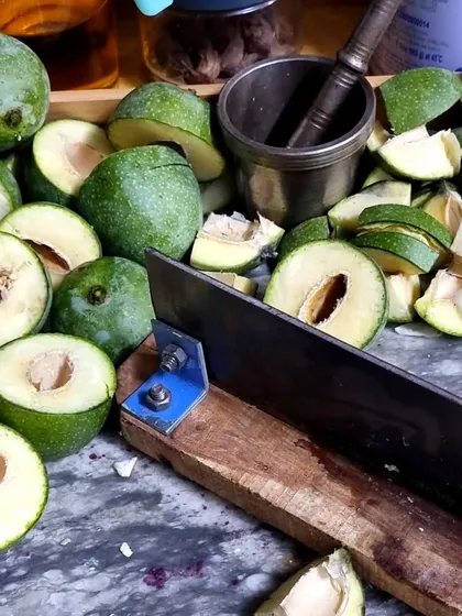 This is where it all begins. I hand-cut fresh, raw mangoes for each batch of pickle. Using traditional tools like this 'sarota' ensures the pieces are the perfect size, just like my dadi used to make.