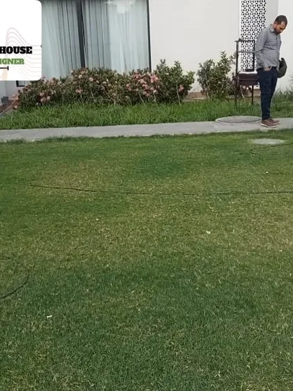 One of our gardeners mowing a client's lawn. Regular maintenance, including mowing, is key to keeping a garden looking its best, and we offer annual contracts for this service.