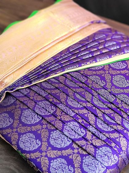 This purple Kanchipuram silk saree has been pre-pleated and box-folded for a bride. The rich color and perfect pleats make for a regal bridal look.