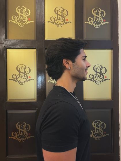 A profile view of this stylish men's haircut, showing how the layers create shape and flow.