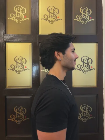 A profile view of this stylish men's haircut, showing how the layers create shape and flow.