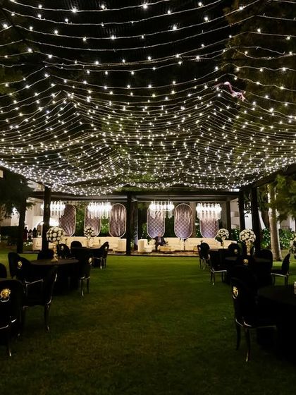 Another view of the enchanting fairy light canopy, creating a vast, starry sky over the entire outdoor Sangeet venue.