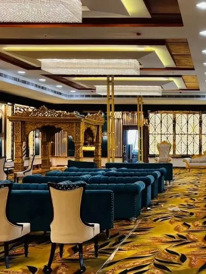 An incredible seating arrangement at Grand Utsav banquet, featuring royal blue sofas and a traditional wooden mandap. This is perfect for a grand, royal-themed wedding.