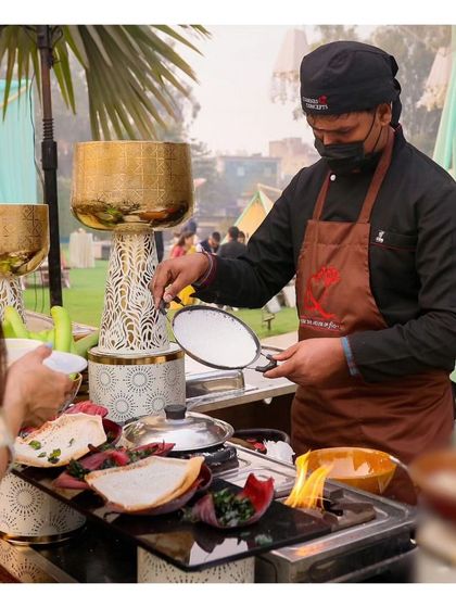 A chef prepares fresh appams, a South Indian specialty, at a live counter. We bring diverse regional Indian cuisines to life with our specialized live stations.