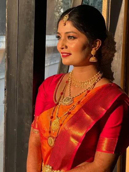 A side profile showcasing the elegant hairstyle and the glow of her makeup.