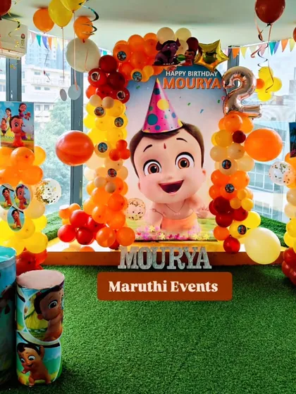 A vibrant party featuring the popular character Chhota Bheem. The orange and yellow balloon decor, character backdrop, and themed plinths create an exciting atmosphere.