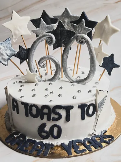 A toast to 60 great years! This milestone birthday cake is our Jack Daniel’s Belgian Chocolate flavor, customized with a fun star theme in black, white, and silver.