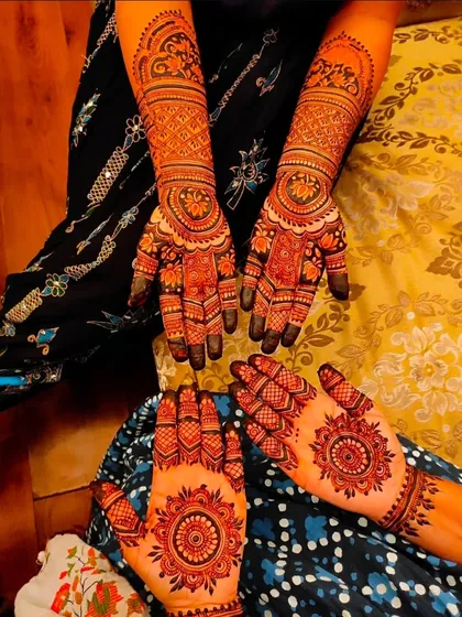 We cater to everyone's taste. This photo shows how we can do a full, traditional bridal arm for one person and a stylish, modern mandala design for another at the same event.