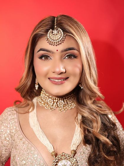 An ethereal day bride look, featuring soft brown eyeshadow, winged liner, and a matte nude lip. The skin is kept fresh and glowing for a natural, sun-kissed finish.