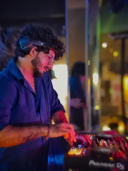 A close-up of me mixing, with the reflection of the club in the background. This shot highlights my focus on the technical side of DJing.