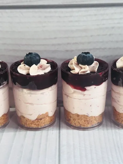 My Blueberry Cheesecake Shots are a party favorite. They have a crunchy biscuit base, a creamy cheesecake layer, and a sweet blueberry topping, all in a bite-sized shot glass.