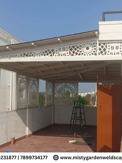 The full installation of the CNC designer frames on the terrace. The series of panels creates a cohesive and artistic screen that defines the outdoor space.