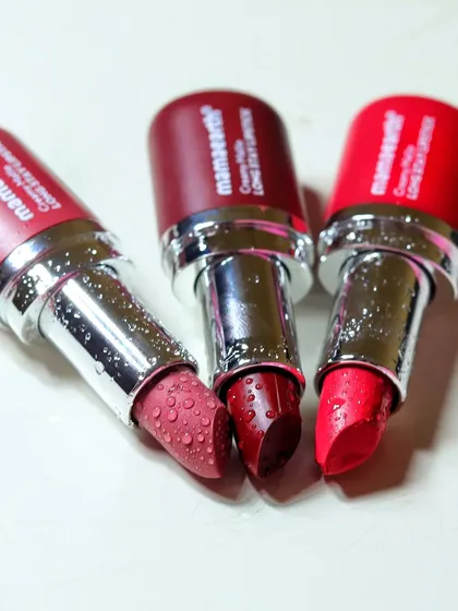 A close-up of three different shades of Mamaearth lipstick, showing the texture and color variety available in the product line.
