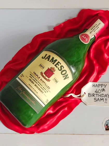This Jameson Irish Whiskey bottle cake is a great example of my 3D sculpted work, perfect for a 40th birthday or a celebration for a whiskey enthusiast. The entire bottle and the rich red fabric it rests on are completely edible and handcrafted.