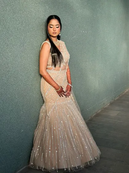 A full-length portrait of this bride in her stunning beige lehenga, looking graceful and elegant.