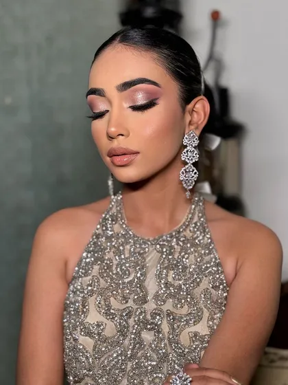 A beautiful shot of the model, highlighting the glamorous makeup that pairs perfectly with this statement hairstyle.
