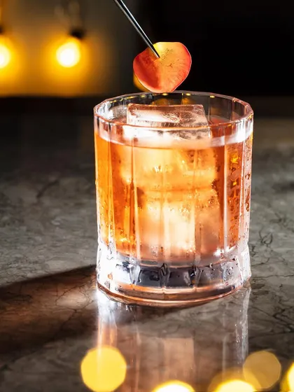 An old-fashioned style cocktail captured for Hakkasan's festive menu. I used warm, ambient light from the background bulbs to create a classic, moody bar atmosphere, with condensation on the glass adding a fresh feel.