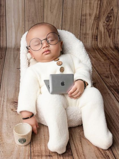 Even the boss needs a nap. This little guy is dreaming of his next big meeting, complete with a tiny laptop and a cup of coffee.