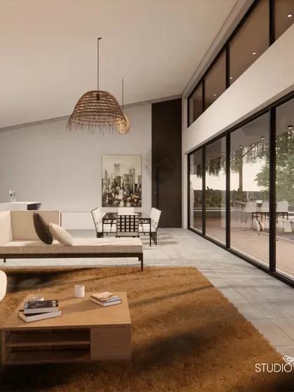 This view shows the open-concept living and dining area of the Pai Residence. The minimalist kitchen and contemporary furniture are set against the dramatic backdrop of the river, seen through a wall of glass that makes the landscape the central feature of the home.
