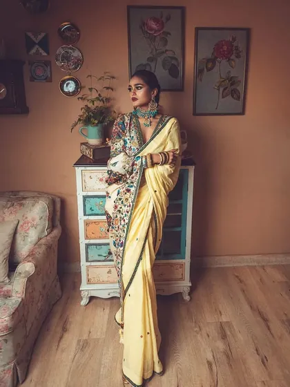 I love mixing vintage vibes with modern style. Here, I styled a beautiful yellow saree with a contemporary, heavily embroidered jacket-style blouse for a high-fashion ethnic look. The entire setup was curated to feel timeless and artistic.