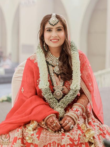 The bride during her ceremony, looking happy and radiant. The makeup is set to withstand tears of joy and long hours of celebration.