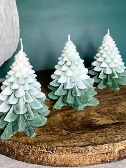 Another view of the ombre green Christmas tree candles on a wooden platter.