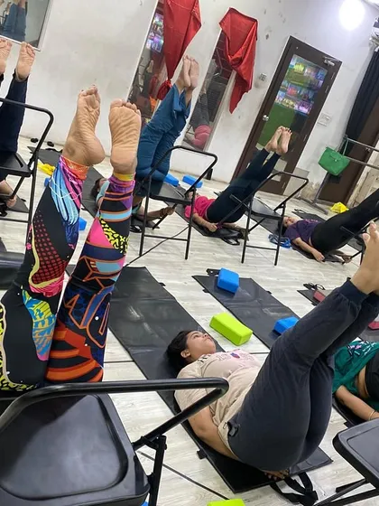 A relaxing pose using the chair for leg support, which helps reduce swelling and fatigue in the legs.