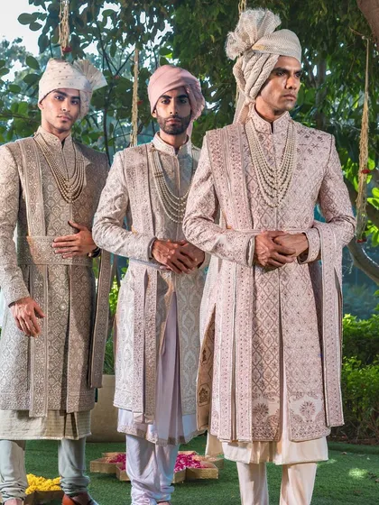 A vision of coordinated grandeur for the groom and his groomsmen. This image showcases a harmonious collection of our bespoke sherwanis in complementary pastel tones, each piece individually tailored yet collectively telling a story of celebration.