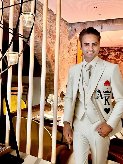 For this client, I created a custom monogram design with the Ace and King of hearts on a sharp, all-white three-piece suit. It’s a subtle yet bold statement, hand-painted to add a touch of personal flair to formal wear.