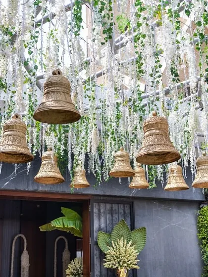 A closer look at the hanging bells and cascading white florals, creating a beautiful and symbolic entrance.