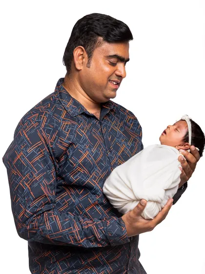 The special connection between a dadda and his newborn. In my studio sessions, I make sure to capture these gentle, unposed interactions that tell the story of your family's love.