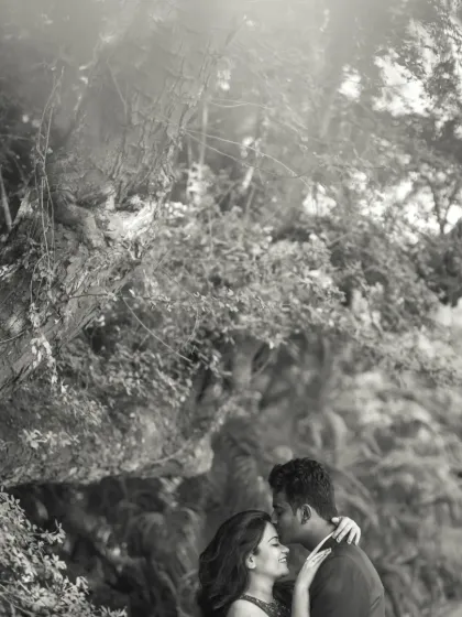 A beautiful black and white portrait of a forehead kiss amidst nature. The monochrome tones add a timeless and emotional quality to this intimate moment.