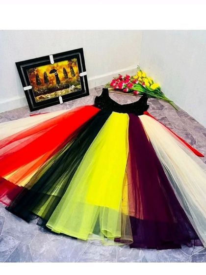 A flat-lay of the multi-colored panel gown, showing the full spectrum of colors in the skirt. This is a fun and unique dress for any celebration.