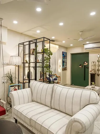 Another angle of the living room from image 22, highlighting the striped sofa and swing.