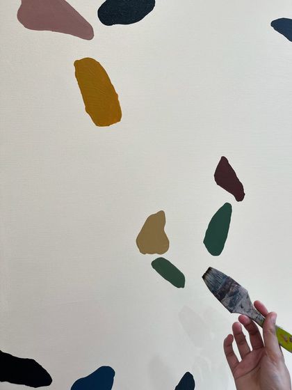 A little behind-the-scenes shot of me painting one of the terrazzo shapes.