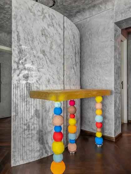 This console table from a Walkeshwar project features playful, stacked, multi-colored legs against a backdrop of Grey Myst marble. It’s a perfect example of how I love to mix bold, artistic elements with refined materials.