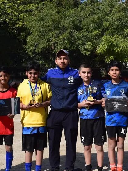 Winning is only half of it, having fun is the other half. A coach stands proudly with the award winners of a recent tournament.
