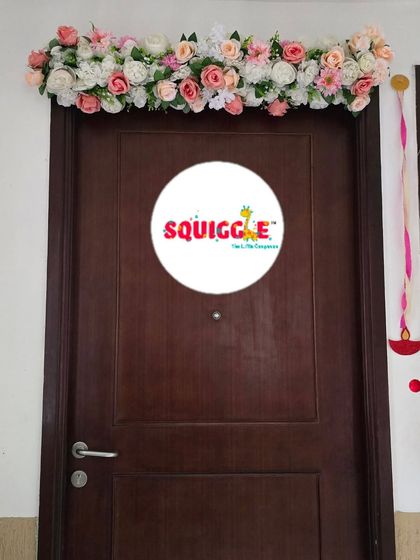 A simple and elegant floral arrangement over a doorway for a housewarming ceremony.