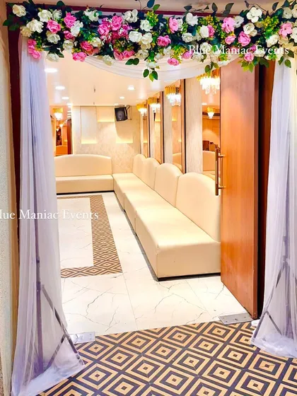 A welcoming entrance for a Roka ceremony, with a simple floral arch and drapes. It sets a beautiful tone for the event as guests arrive.