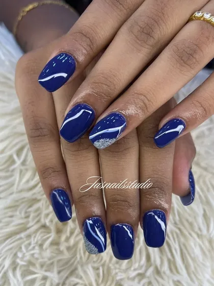 A deep navy blue set with abstract white swirls and a silver glitter accent. This design is chic and modern.
